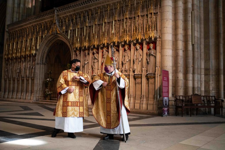 The Right Reverend Dr. Jonathan Frost, the Dean of York, left, and The Archbishop of York, The Most Reverend Stephen Cottrell, bump elbows after the Festal Eucharist for Easter Day in York Minster, in York, northern England, on Sunday.