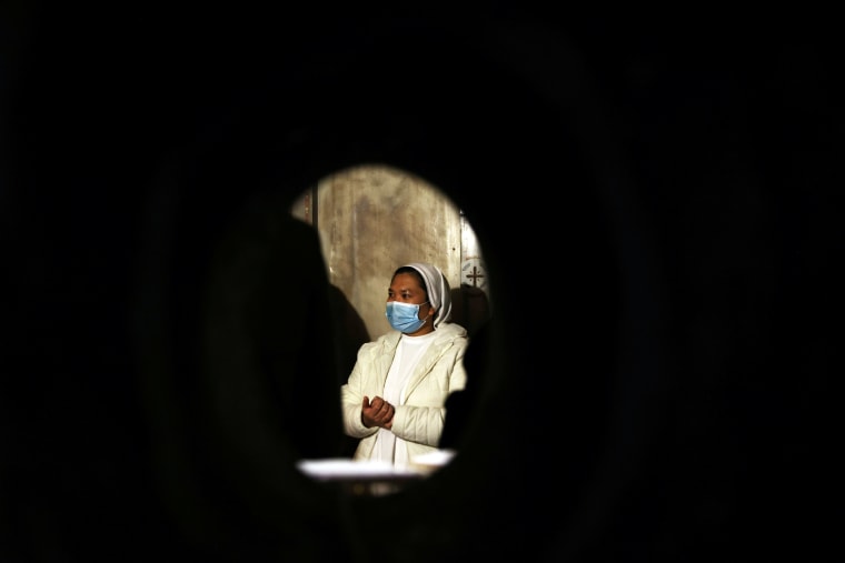 A Christian nun attends Easter Sunday Mass at the Church of the Holy Sepulchre in Jerusalem's Old City.
