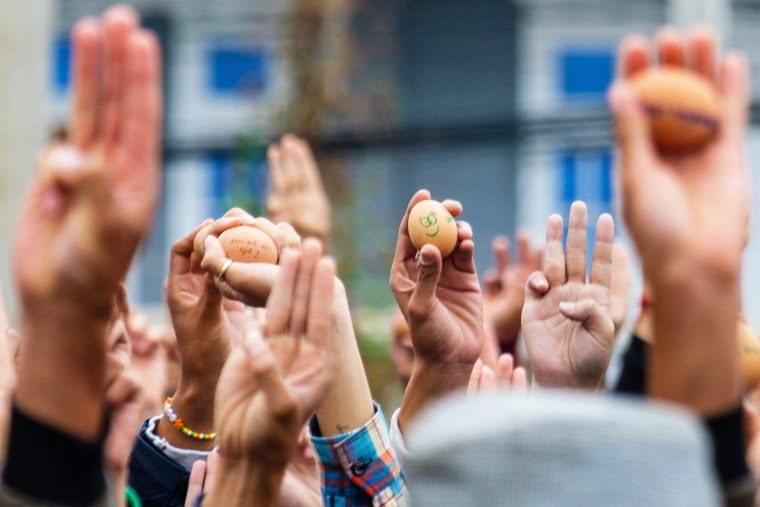 Protesters hold eggs on Easter Sunday and make the three-finger salute during a demonstration against the military coup in Taunggyi in Myanmar's Shan state.
