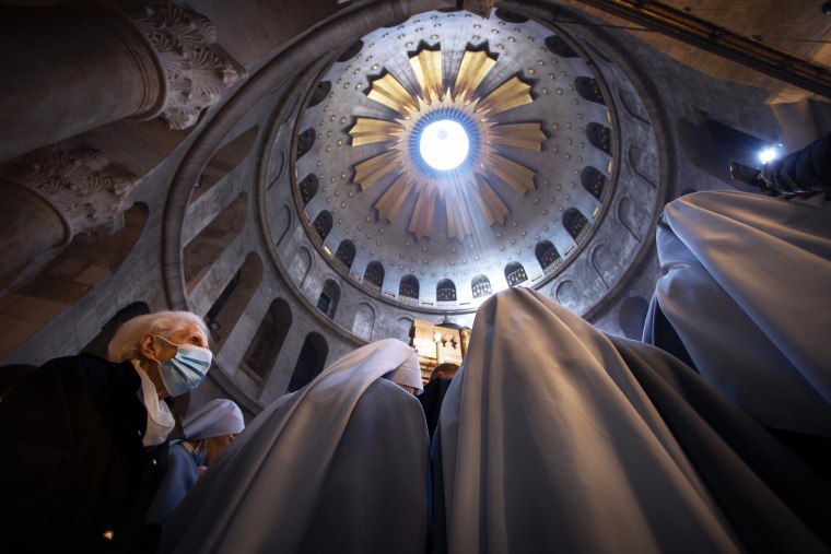 A woman attends Easter Sunday mass led by Latin Patriarch of Jerusalem Pierbattista Pizzaballa at the Church of the Holy Sepulchre, where Jesus Christ is believed to be buried, in the Old City of Jerusalem.