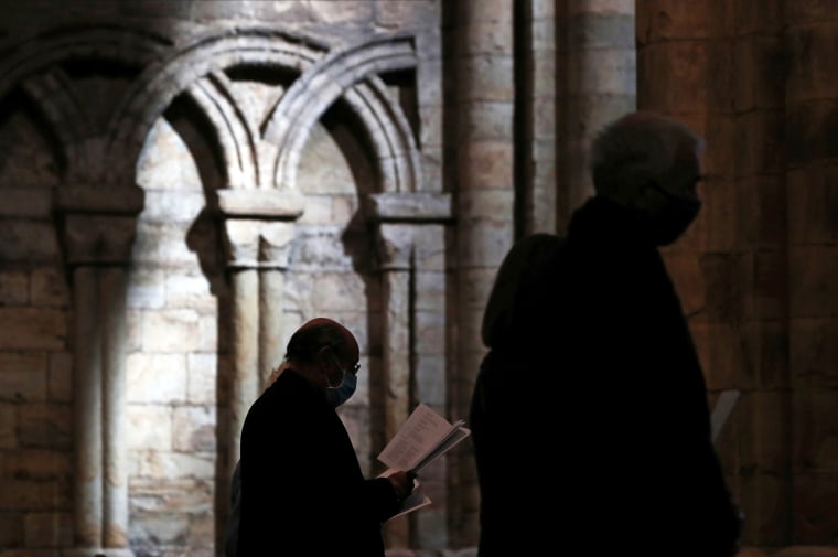Congregants observe the the Easter Sunday Eucharist service at Durham Cathedral in Durham, Britain.
