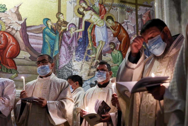 Fransiscan friars pray during mass on Easter Sunday at the Church of the Holy Sepulchre in Jerusalem.