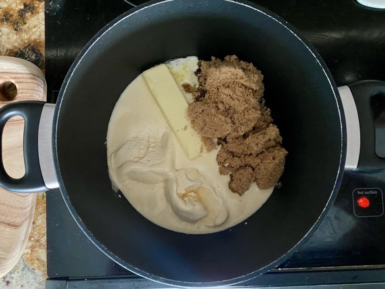 Once the vanilla ice cream, butter, brown sugar and cinnamon melt together, keep them simmering until boiling before pouring the mixture over frozen yeast rolls.
