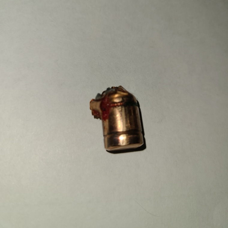 a used bullet against a white background