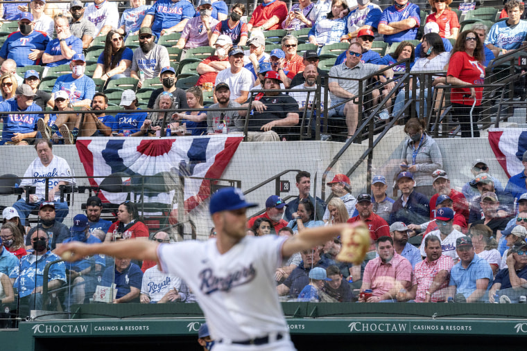 Image: Texas Rangers fans watch relief pitcher Kyle Cody work against the Toronto Blue Jays during the seventh inning of a game April 5, 2021, in Arlington, Texas.