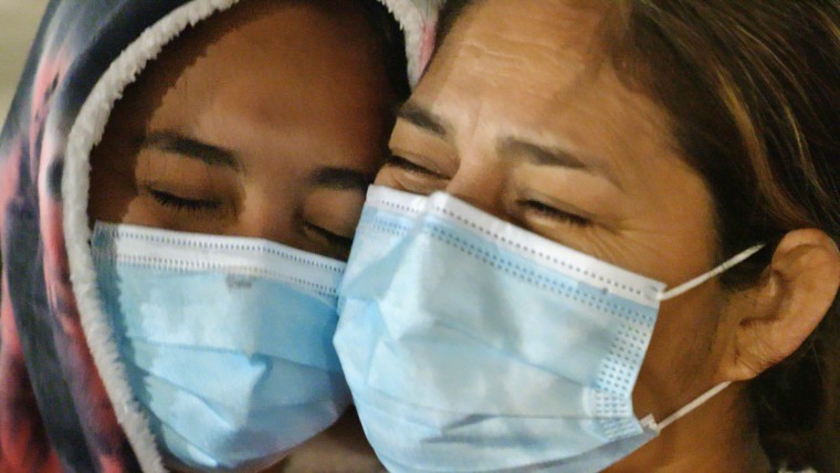 Cindy, an unaccompanied teen from Honduras, left, is reunited with her mother after the teen was hospitalized with Covid-19.