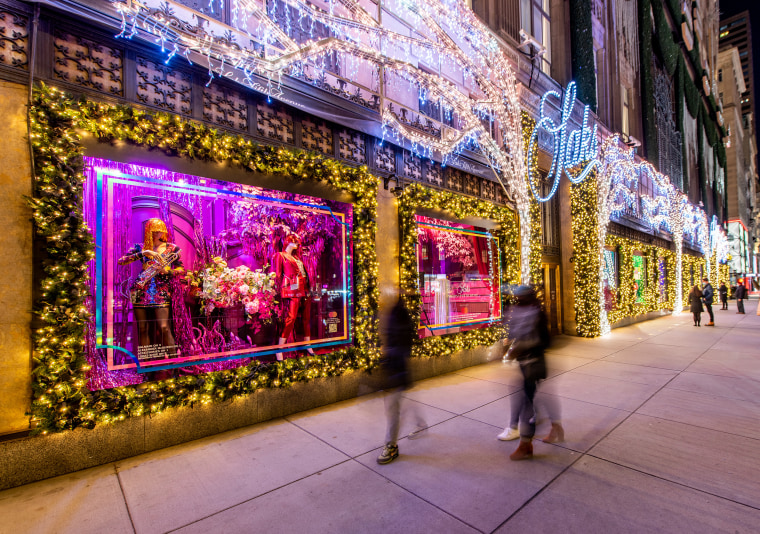 Image: Visitors look at Christmas window displays at Saks Fifth Avenue on Dec. 1, 2020 in New York City.