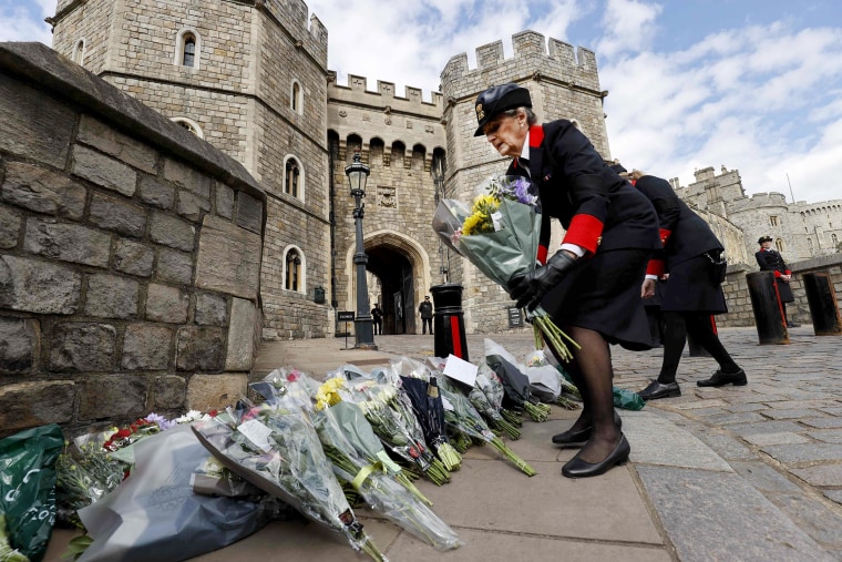 Image: Wardens of the Castle move floral tributes to the side of the driveway at the Henry VIII Gate of Windsor Castle, in Windsor, west of London