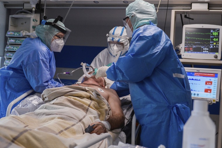 Image: Health workers attend to a critical patient in the Intensive care Unit at the hospital in Bochnia, Poland, on March 26, 2021.