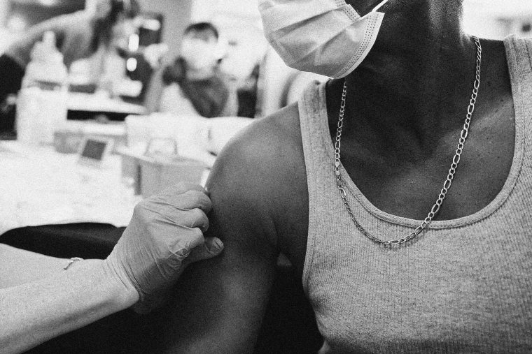 Image: A man receives a Band-Aid from a nurse after his second dose of the Moderna COVID-19 vaccine on March 12, 2021 in Los Angeles.