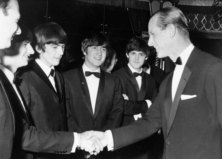 Britain's Prince Philip shakes hands with Ringo Starr as co-Beatles from left, George Harrison, John Lennon and Paul McCartney look on, at the Empire Ballroom in London on March 23, 1964.