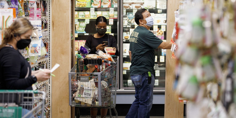 Customers and employees wear protective masks inside a grocery store in West Covina, Calif., on May 29, 2020.