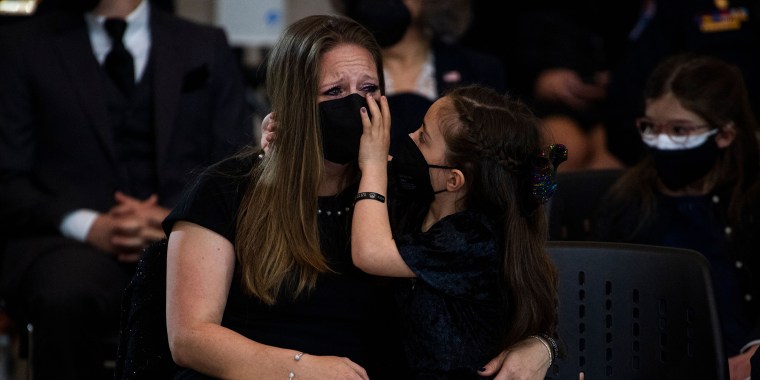 Abigail Evans wipes away her mother's tears during the memorial service for her father, slain Capitol Police officer William Evans.