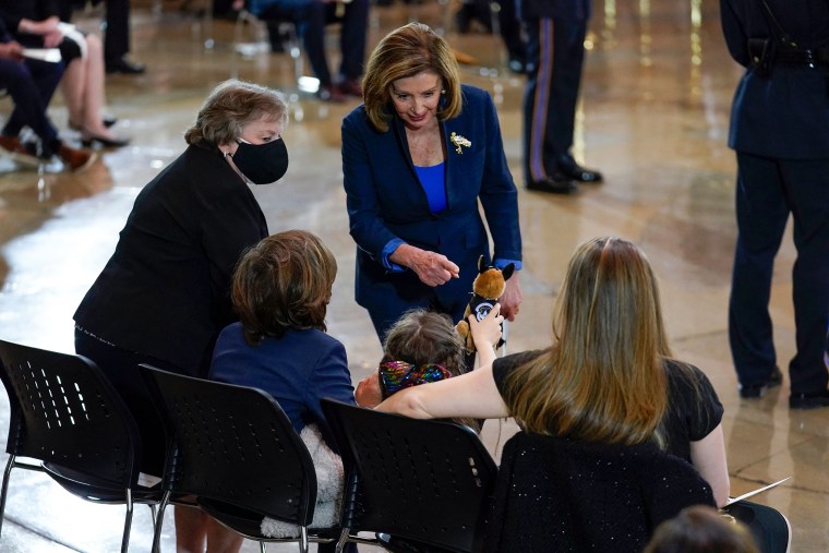 Abigail Evans shows a stuffed toy to House Speaker Nancy Pelosi. 