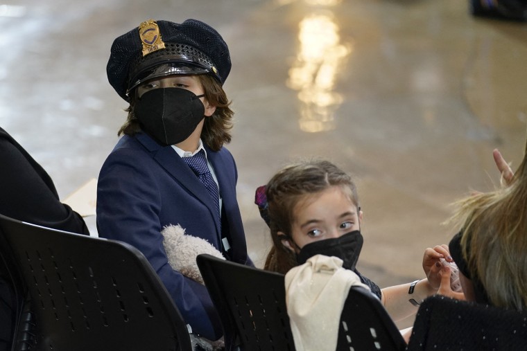 Logan Evans was photographed wearing a police cap during his father's memorial service. 