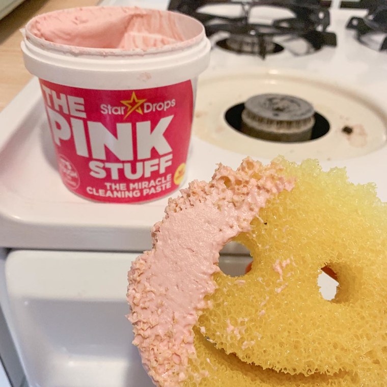 Emma Stessman shows a yellow sponge with The Pink Stuff used for cleaning tough stains