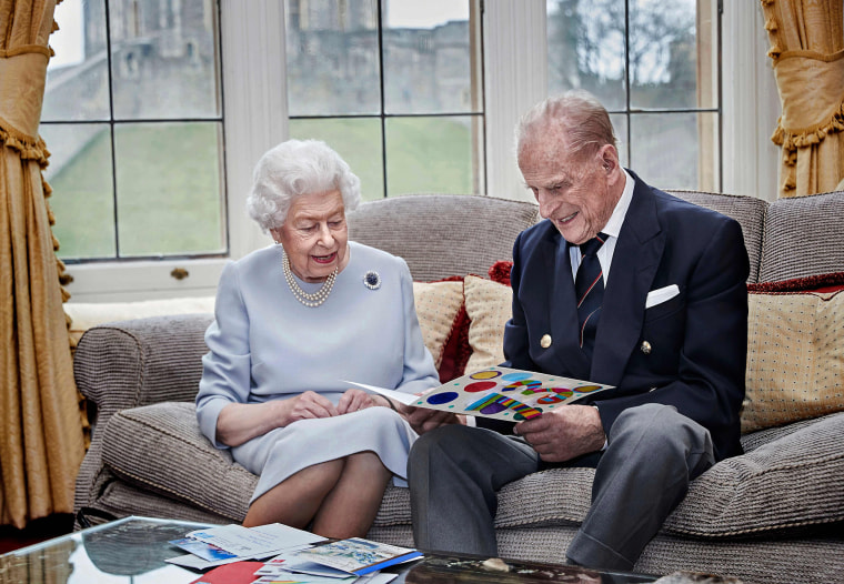 Image: Britain's Queen Elizabeth II and Britain's Prince Philip, Duke of Edinburgh look at a homemade wedding anniversary card