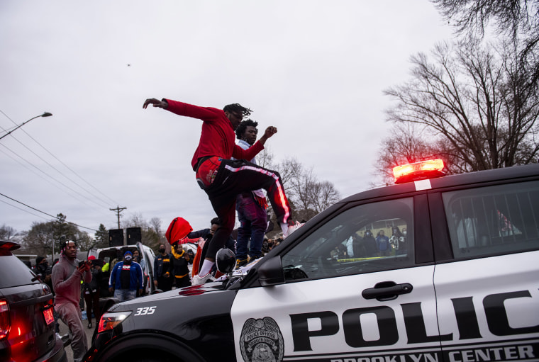 Image: A man stomps the windshield of a police cruiser as people protest after Brooklyn Center police shot and killed Daunte Wright during a traffic stop