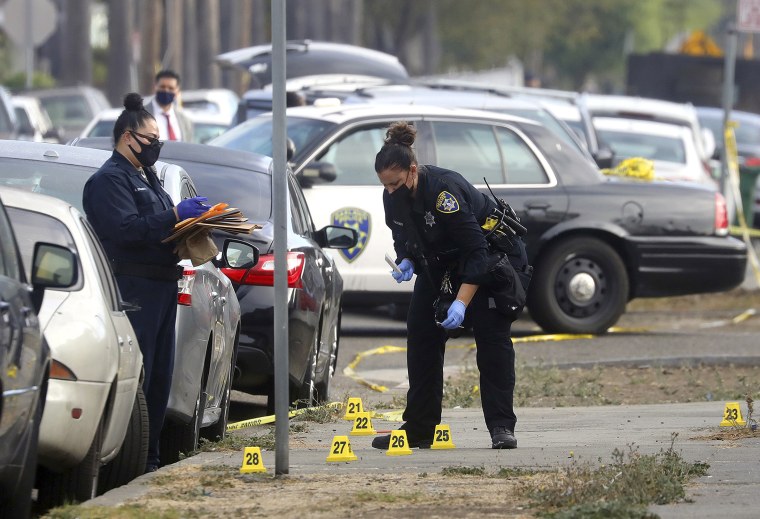 Image: Oakland police officers investigate a shooting with a police officer at a marijuana business