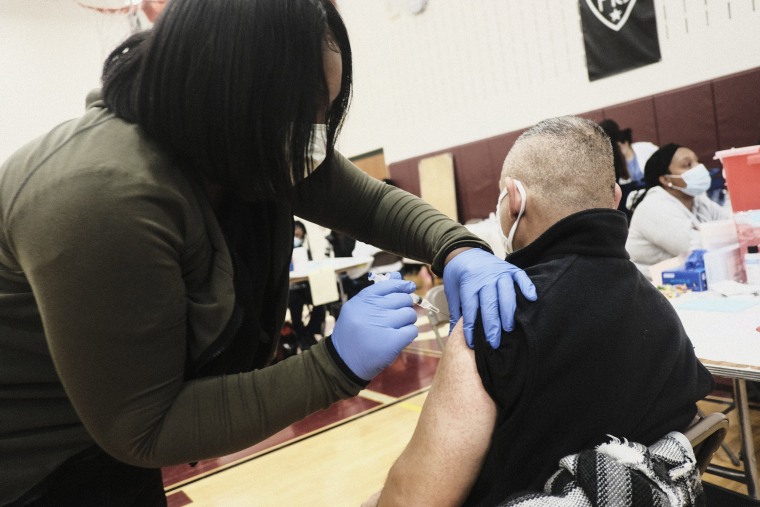 Image: Volunteer medical staff administer Covid-19 vaccines to walk-in patients during a pop-up clinic at Western International High School on April 12, 2021 in Detroit, Mich.