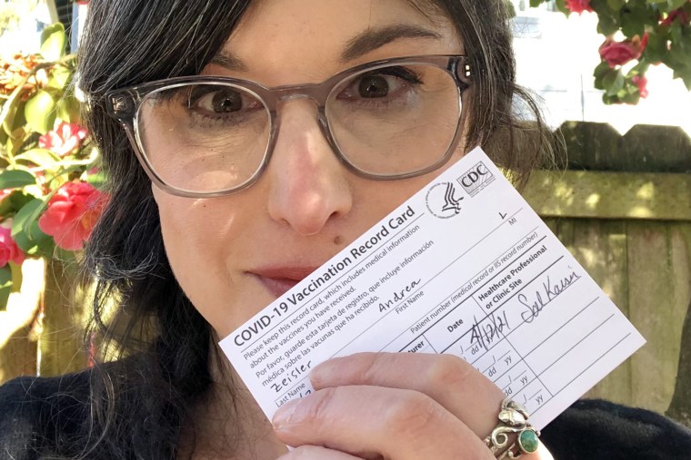 Writer Andi Zeisler displays her Covid-19 vaccination card after getting the Johnson & Johnson shot.