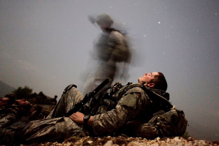 Image: A U.S. soldier takes a break during a night mission near Honaker Miracle camp at the Pesh valley of Kunar Province, Afghanistan.