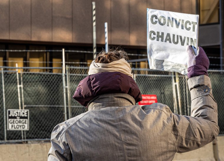 A woman protests outside the Hennepin County Government Center, where the trial of former police officer Derek Chauvin is being held, in Minneapolis on March 31, 2021.