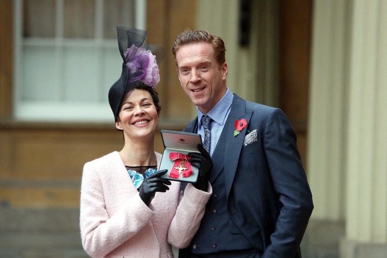 Image: English actress Helen McCrory with her husband Damian Lewis after she was awarded an Officer of the Most Excellent Order of the British Empire (OBE) for services to drama