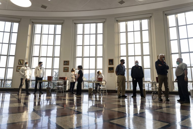 Medical professionals wait for the first students to arrive, during a vaccination event in Riggleman Hall on the campus of the University of Charleston on April 8, 2021.