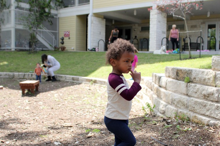 Sydney Martens' daughter, Amiyah, plays outside the Jeremiah Program complex in Austin.