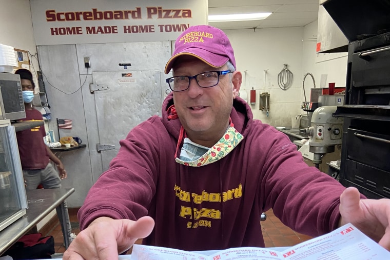 Image: Jim Johnson, owner of Scoreboard Pizza takes a pose. The pizzeria has been giving away free pizza