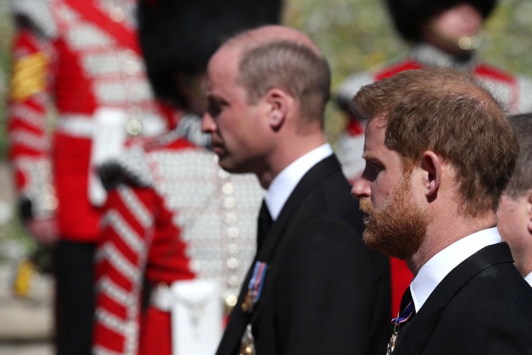 Image: Princes William and Harry follow the Land Rover Defender carrying Prince Philip's coffin at Windsor Castle.