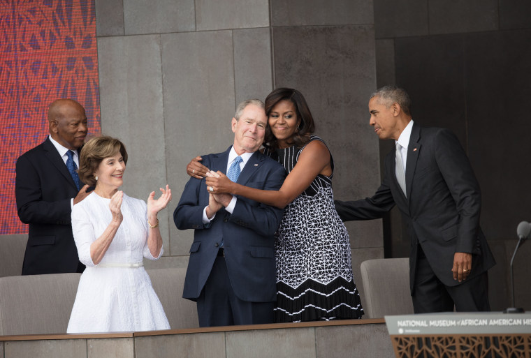 First lady Michelle Obama hugs former President George W. Bush