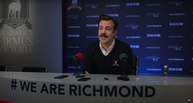 Ted Lasso's (Jason Sudeikis) upbeat charm wins over even the press.