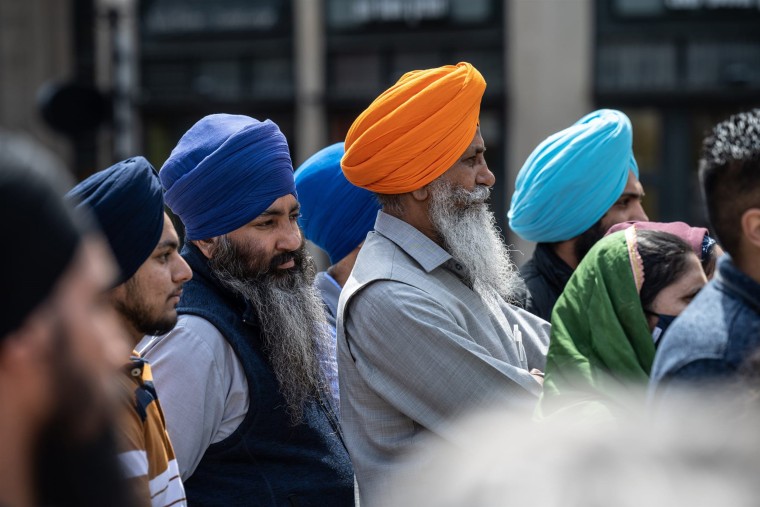Members of the Sikh community gather and listen during a vigil at Monument Circle on April 18, 2021, in Indianapolis.