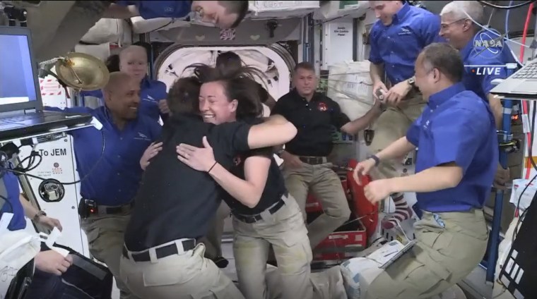 Astronauts from SpaceX are greeted by the astronauts from the International Space Station after the Dragon capsule successfully docked on Saturday.