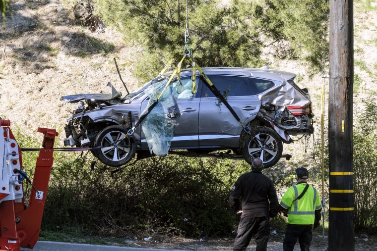 Image: A crane is used to lift a vehicle following a rollover accident involving golfer Tiger Woods on Feb. 23, 2021, in the Rancho Palos Verdes suburb of Los Angeles.