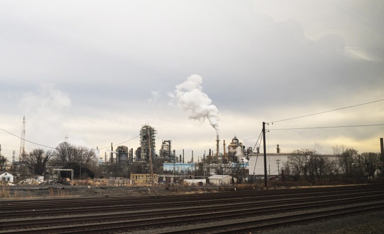 Industrial pollution pours from an oil refinery on Jan. 8, 2021, near New Castle, Del.