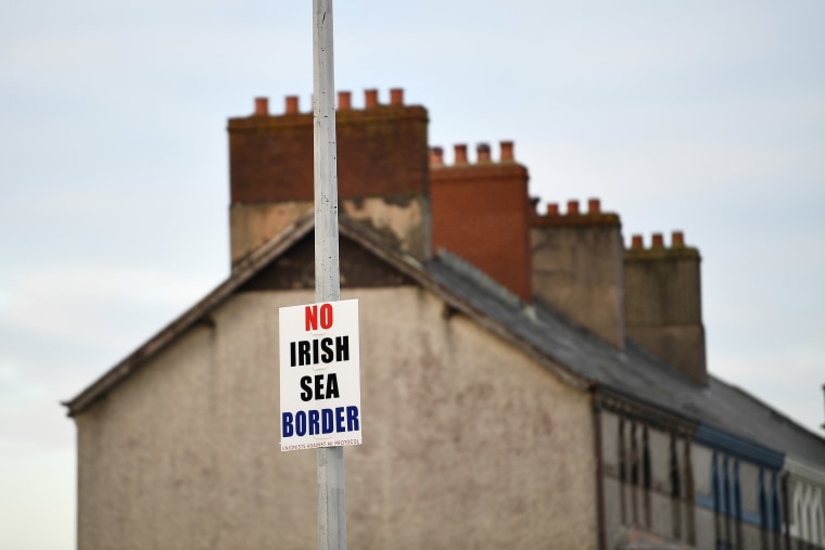 Image: A sign reading 'No Irish Sea border' is seen affixed to a lamp post in the Port of Larne, Northern Ireland