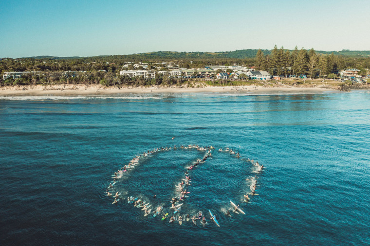 Image: The "paddle out" held by local surfers in Byron Bay, Australia.