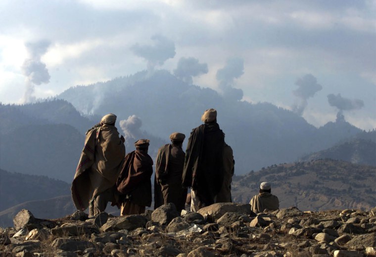 Image: AFGHAN FIGHTERS WATCH SEVERAL EXPLOSIONS FROM US BOMBINGS IN THE TORABORA MOUNTAINS.