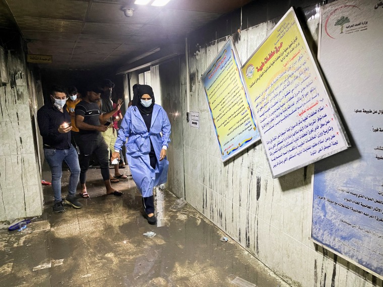 Image: People and medical staff members walk at Ibn al-Khatib hospital