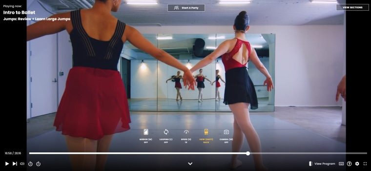 You can switch the camera view so that you're following along behind the instructor as you would in a dance class.