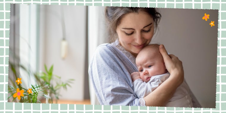 Loving and affectionate mother holding newborn baby indoors at home