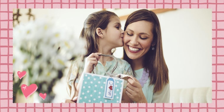 Daughter kissing her mother as she gives her a gift for Mother's Day