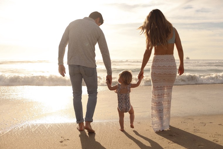 Katrina Scott and her husband, Brian, with their daughter, Isabelle, near their home in California. 