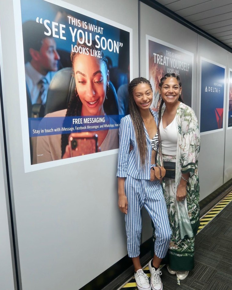 Natalia and her mom pose with her Delta ad in 2019.