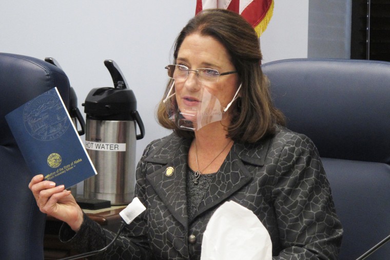 Alaska state Sen. Lora Reinbold holds a copy of the Alaska Constitution during a committee hearing in Juneau on Jan. 27, 2021.