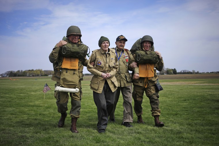 World War II paratrooper veterans Jim \"Pee Wee\" Martin and Dan McBride walk across the drop zone at Pee Wee's Jump Fest in Xenia, Ohio.