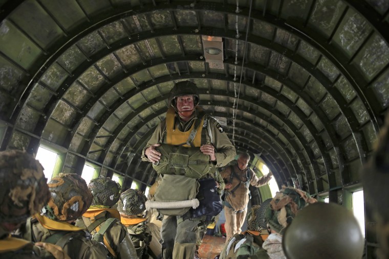 Members of the WWII Airborne Demonstration Team ride inside Placid Lassie, a vintage C-47 Skytrain, before parachuting into Pee Wee's Jump Fest.